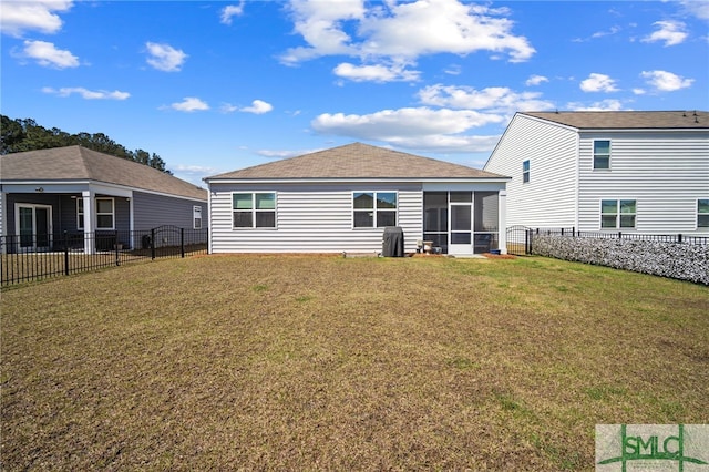 back of property featuring a lawn, a fenced backyard, and a sunroom