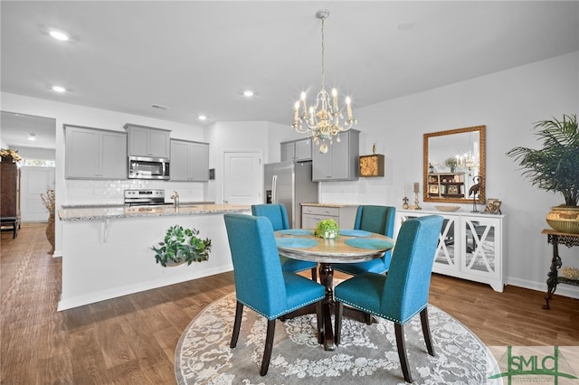 dining room featuring recessed lighting, dark wood-style floors, and baseboards