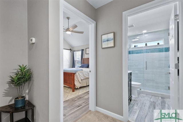 full bathroom with a ceiling fan, baseboards, ensuite bath, a stall shower, and toilet