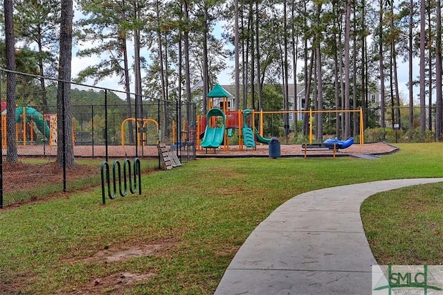 community playground featuring a lawn and fence