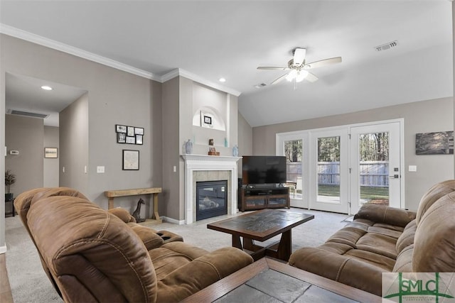 living area featuring a tiled fireplace, visible vents, baseboards, and carpet floors