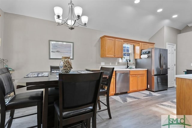 dining space featuring light wood finished floors, a notable chandelier, recessed lighting, and lofted ceiling