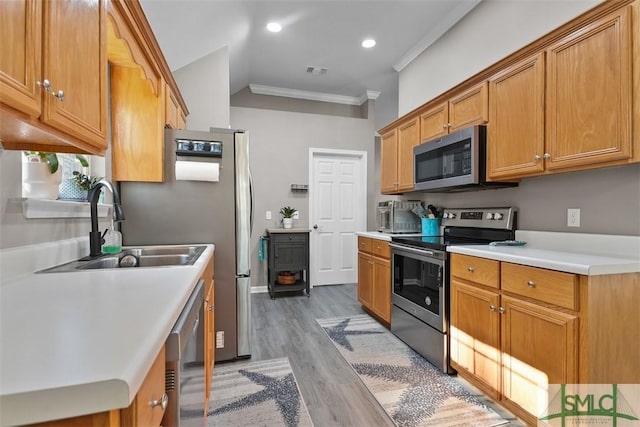 kitchen with visible vents, ornamental molding, a sink, stainless steel appliances, and light countertops