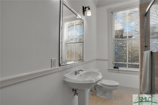 bathroom featuring toilet and tile patterned flooring