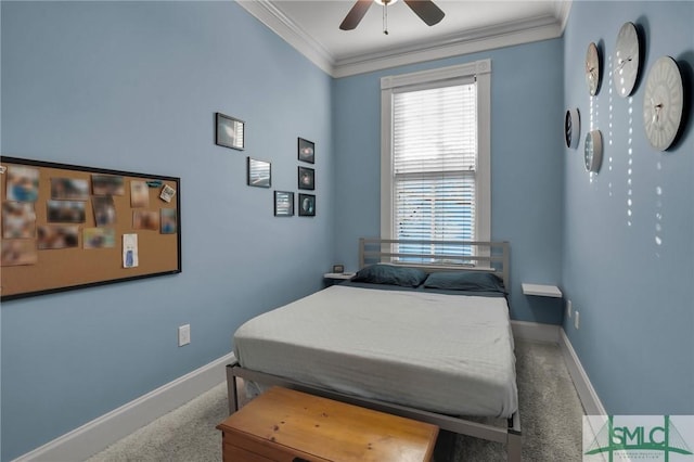 carpeted bedroom featuring ceiling fan, baseboards, and ornamental molding