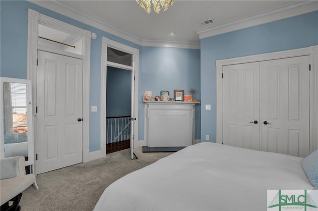 carpeted bedroom featuring visible vents, baseboards, and ornamental molding