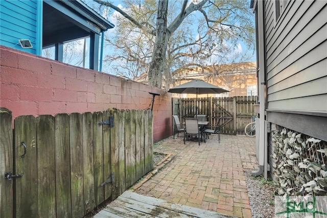 view of patio featuring outdoor dining space and a fenced backyard