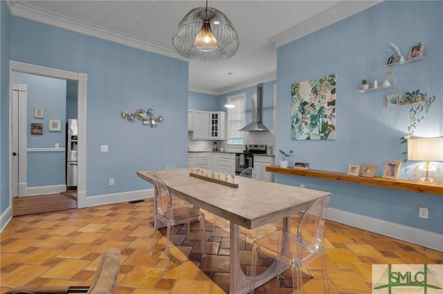 dining room featuring a notable chandelier, baseboards, and ornamental molding