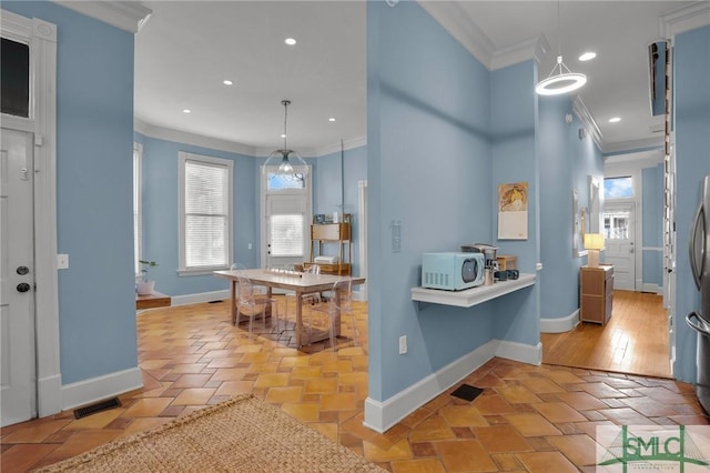 kitchen with visible vents, recessed lighting, crown molding, baseboards, and white microwave