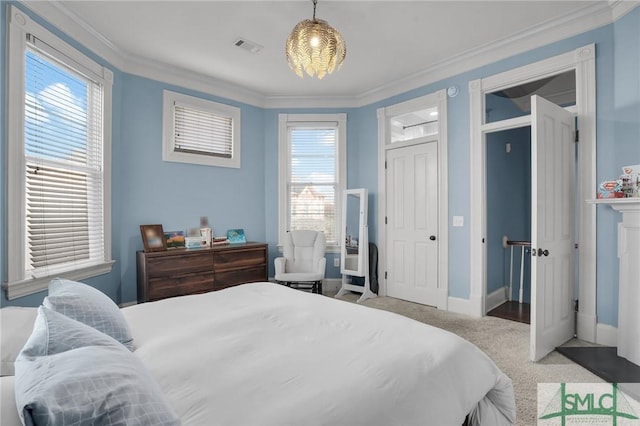 bedroom featuring baseboards, visible vents, carpet floors, and ornamental molding