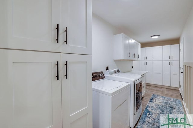 laundry area featuring cabinet space and washer and clothes dryer