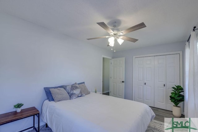 bedroom with wood finished floors, a closet, and ceiling fan