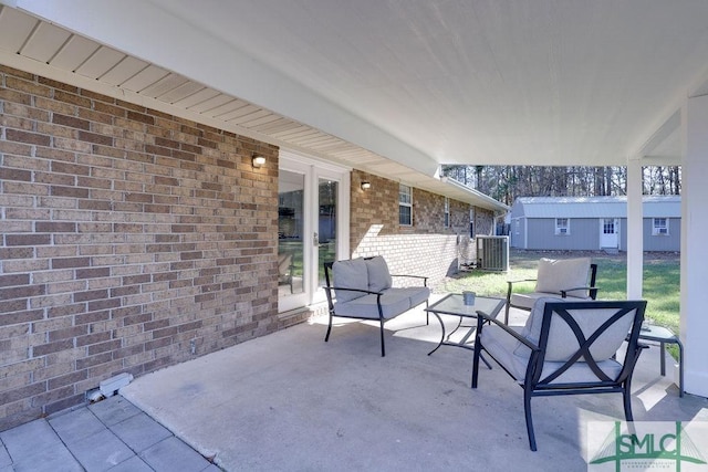 view of patio / terrace with an outdoor living space and central AC