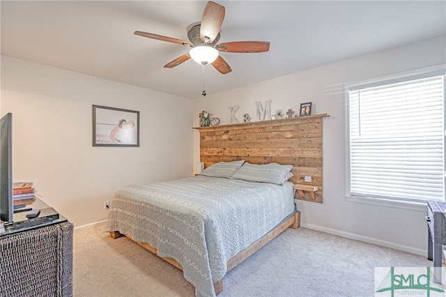 bedroom featuring baseboards, multiple windows, and carpet flooring