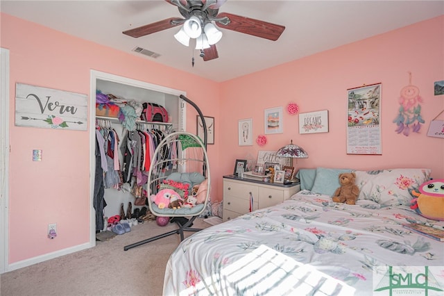 carpeted bedroom featuring visible vents, baseboards, a closet, and a ceiling fan