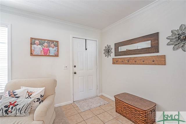 entryway with light tile patterned floors, crown molding, and baseboards