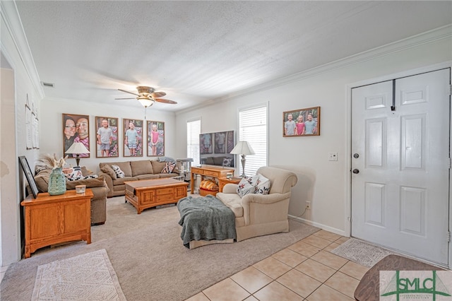 living room featuring visible vents, a textured ceiling, crown molding, light tile patterned floors, and ceiling fan