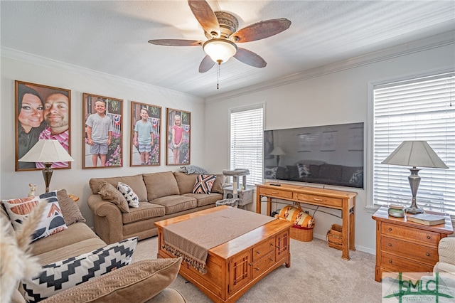 living area featuring light colored carpet, crown molding, and ceiling fan