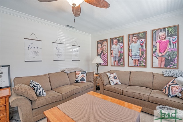 living area with visible vents, a ceiling fan, and crown molding