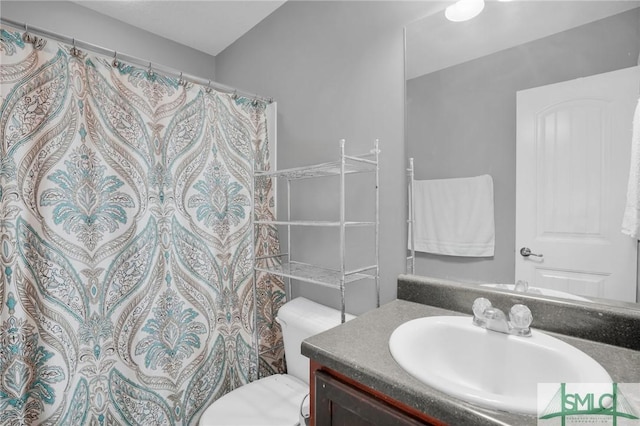 bathroom featuring a shower with shower curtain, toilet, and vanity