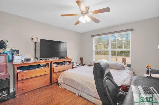 bedroom featuring a ceiling fan and wood finished floors