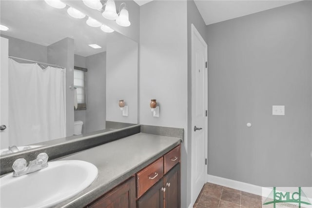 bathroom featuring a shower with curtain, toilet, tile patterned flooring, baseboards, and vanity