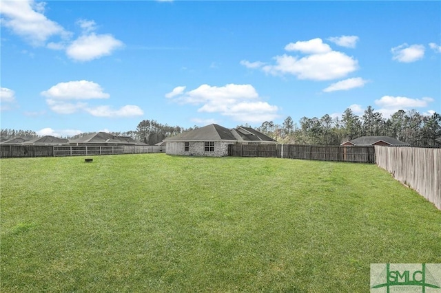 view of yard with a fenced backyard