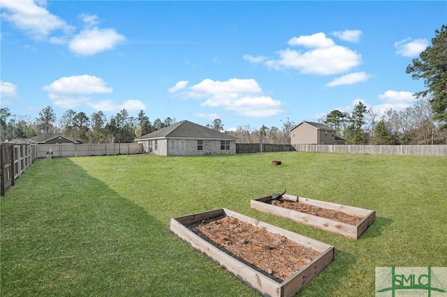 view of yard featuring a fenced backyard and a vegetable garden