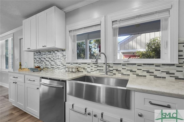 kitchen featuring a sink, white cabinets, crown molding, decorative backsplash, and dishwasher