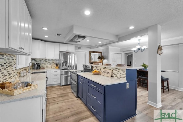 kitchen with blue cabinetry, double oven range, a sink, white cabinetry, and stainless steel fridge with ice dispenser