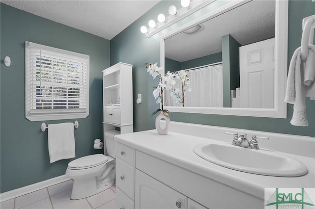 full bathroom featuring baseboards, toilet, vanity, tile patterned floors, and a textured ceiling