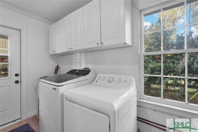 laundry room featuring cabinet space, independent washer and dryer, and ornamental molding