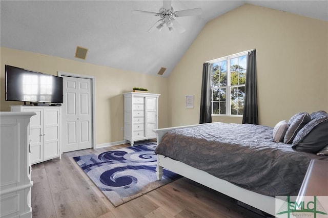 bedroom with visible vents, a ceiling fan, lofted ceiling, and wood finished floors