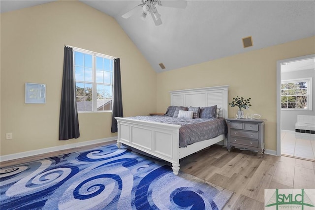 bedroom with visible vents, a ceiling fan, wood finished floors, baseboards, and lofted ceiling