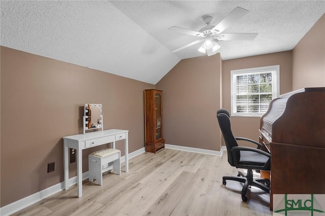 office with a ceiling fan, a textured ceiling, wood finished floors, baseboards, and vaulted ceiling