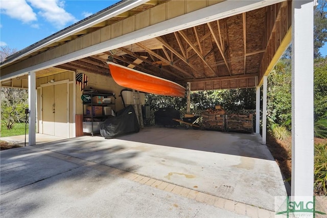 view of patio / terrace featuring a carport and concrete driveway