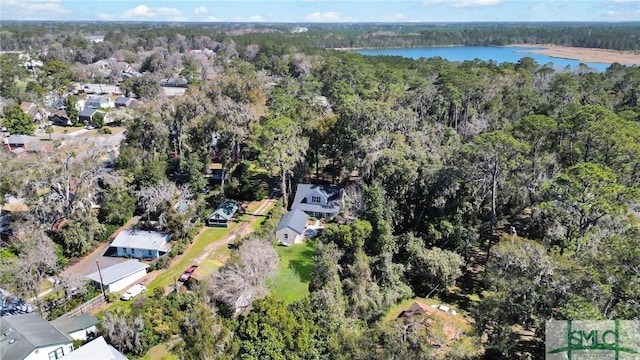 aerial view with a forest view and a water view