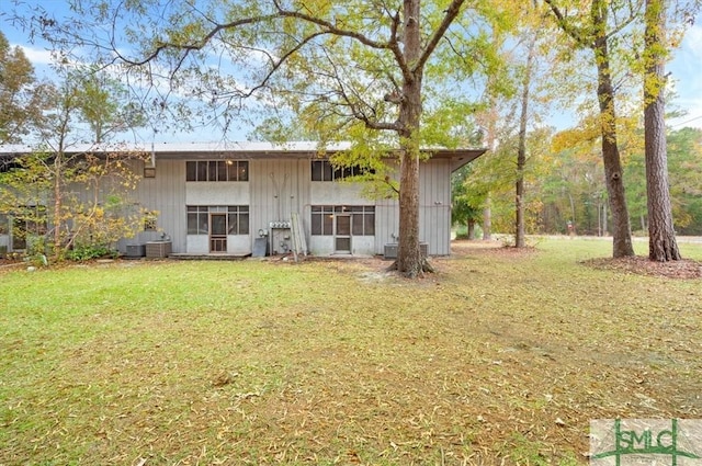 back of house with a lawn