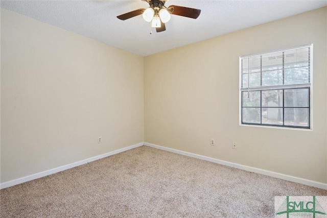 empty room featuring baseboards, ceiling fan, and carpet floors