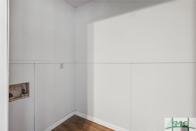 washroom with dark wood finished floors, hookup for a washing machine, and laundry area