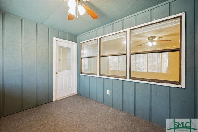 unfurnished sunroom with ceiling fan