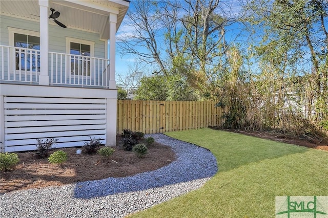 view of yard with fence and covered porch