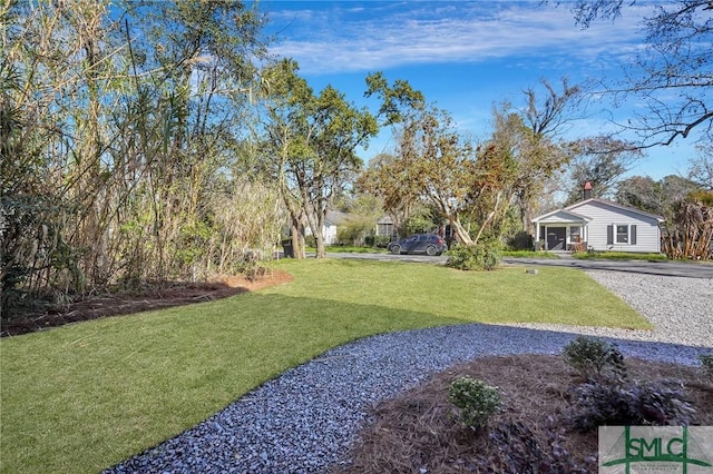 view of yard with gravel driveway