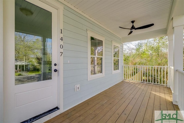 wooden deck with a ceiling fan