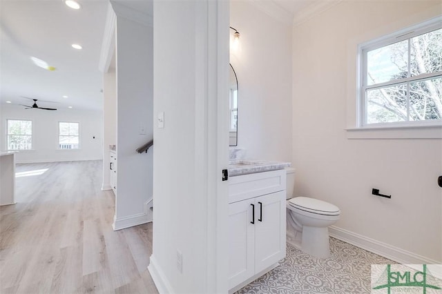 bathroom with baseboards, toilet, ornamental molding, recessed lighting, and vanity