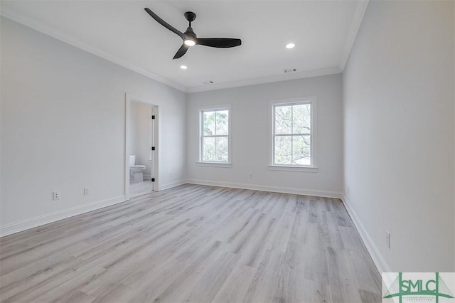 spare room featuring light wood finished floors, visible vents, crown molding, and baseboards