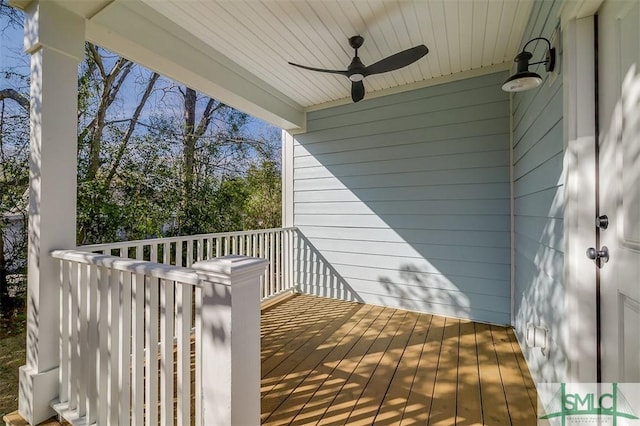 wooden deck featuring ceiling fan