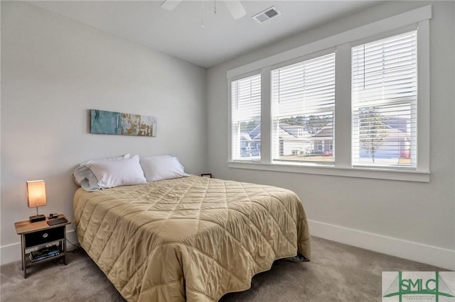 bedroom with ceiling fan, carpet, visible vents, and baseboards