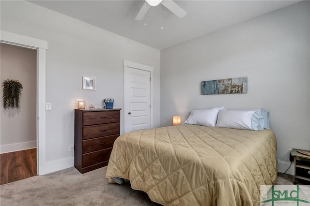 carpeted bedroom featuring baseboards and ceiling fan