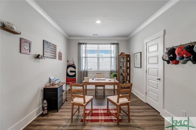 dining space with visible vents, baseboards, ornamental molding, and dark wood finished floors